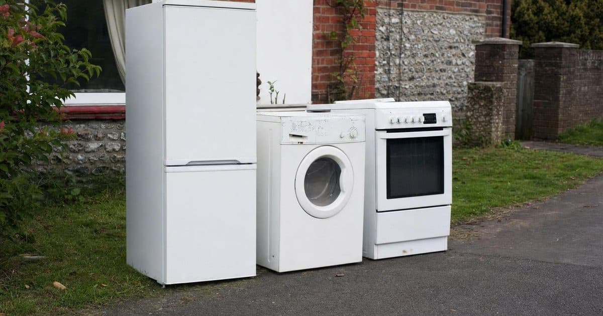 Old white goods including a fridge and washing machine ready for disposal in Salisbury